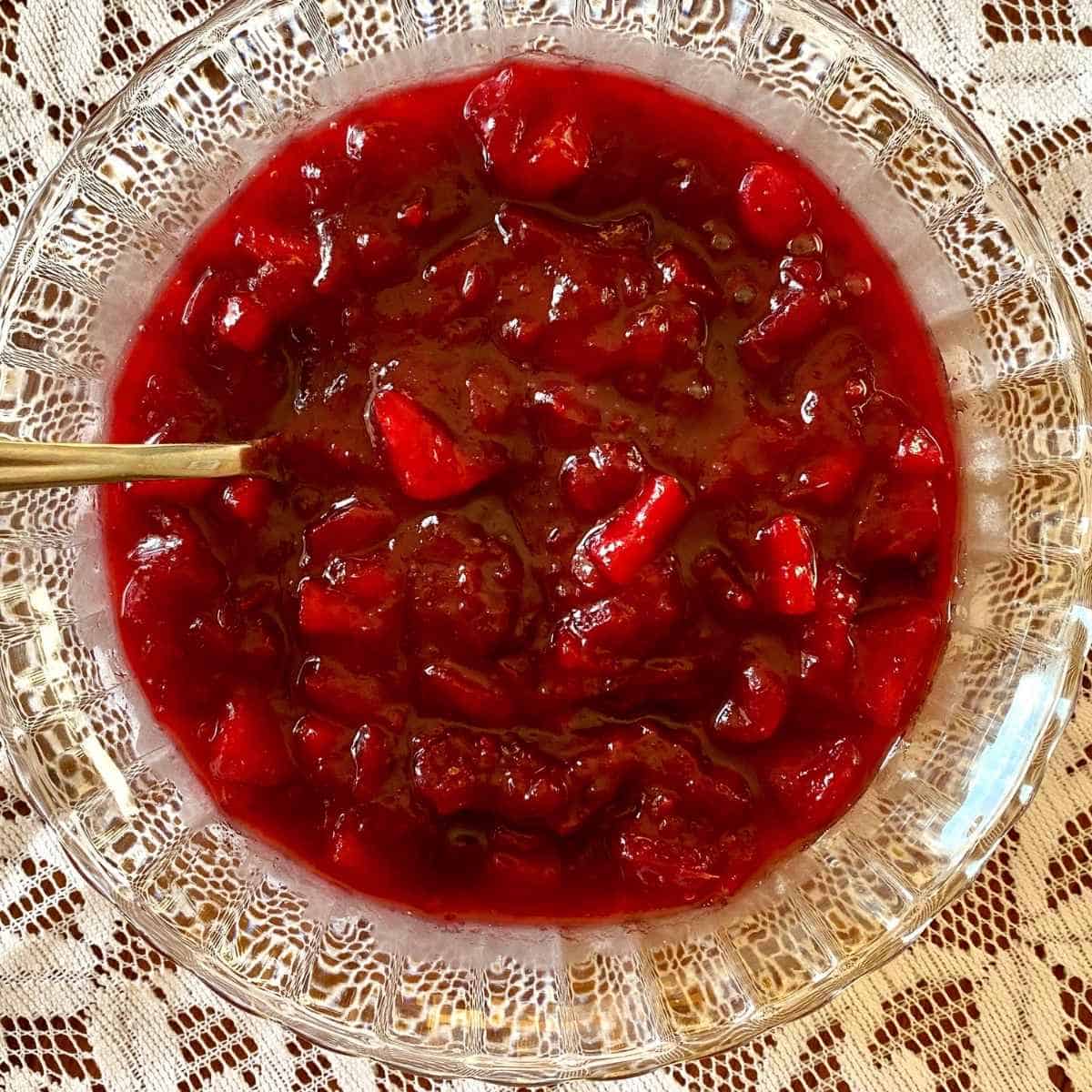 An overhead photo of cranberry apple sauce in a glass bowl.