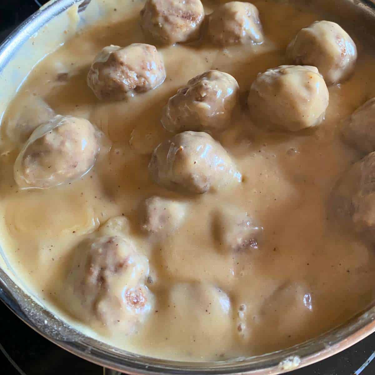 Egg free Swedish meatballs added to gravy in a large skillet.