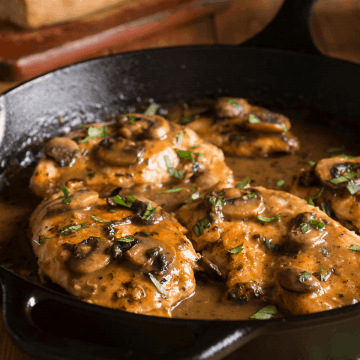 A pan with Veal Marsala garnished with fresh parsley
